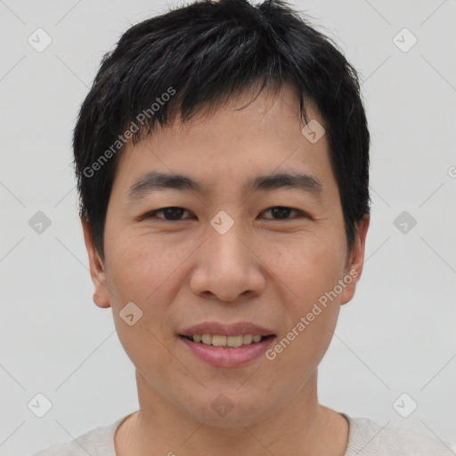 Joyful asian young-adult male with short  black hair and brown eyes