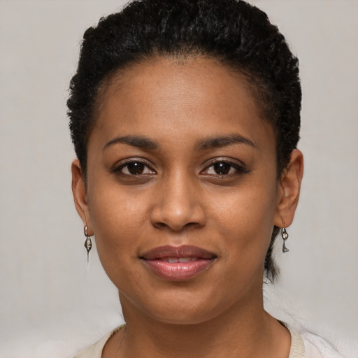 Joyful black young-adult female with short  brown hair and brown eyes