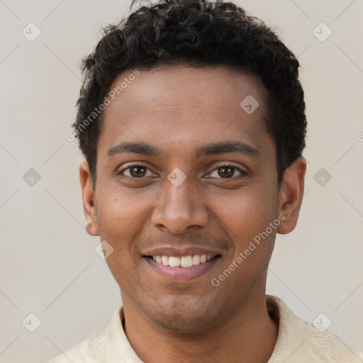 Joyful black young-adult male with short  brown hair and brown eyes