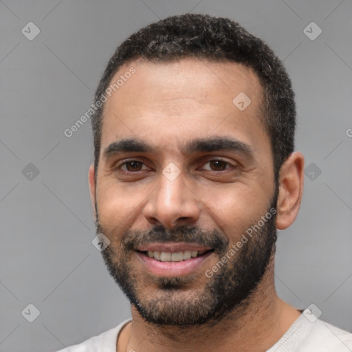 Joyful white young-adult male with short  black hair and brown eyes