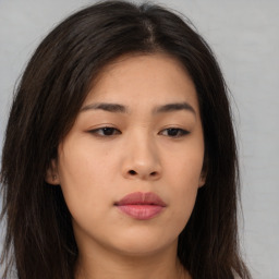 Joyful asian young-adult female with long  brown hair and brown eyes