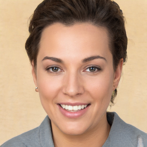 Joyful white young-adult female with short  brown hair and brown eyes