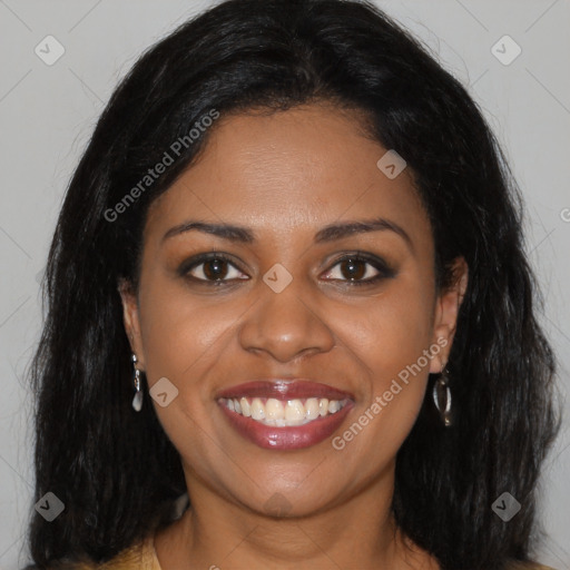 Joyful black young-adult female with long  brown hair and brown eyes