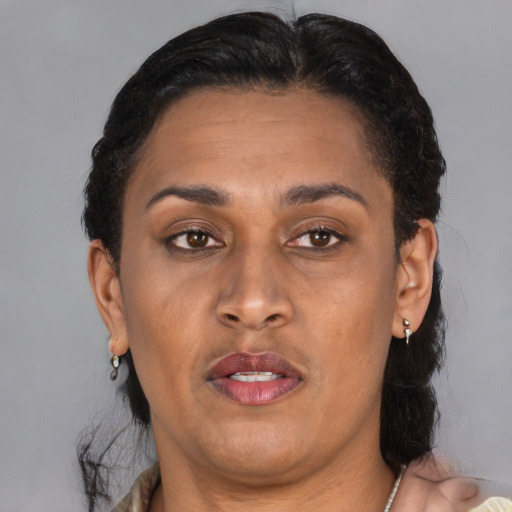 Joyful latino adult female with short  brown hair and brown eyes