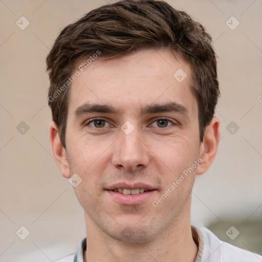 Joyful white young-adult male with short  brown hair and grey eyes