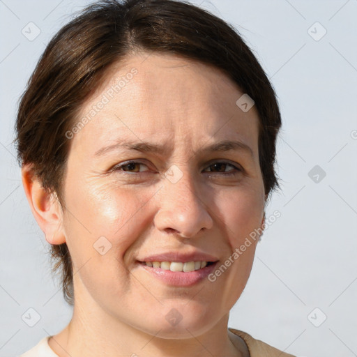 Joyful white adult female with medium  brown hair and brown eyes