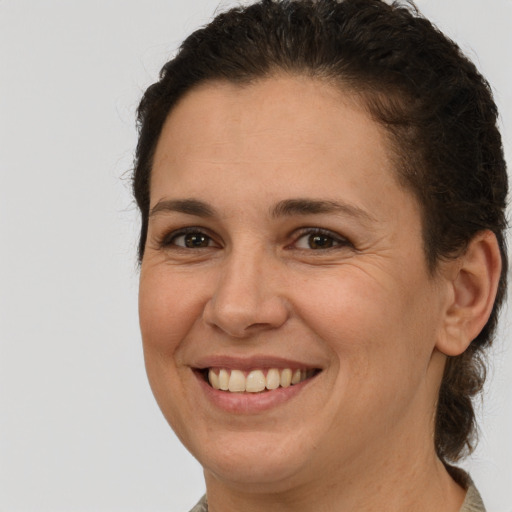 Joyful white adult female with short  brown hair and brown eyes