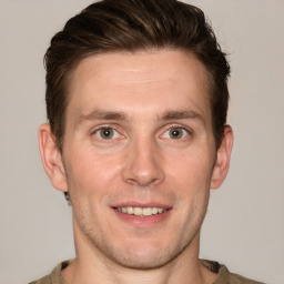 Joyful white adult male with short  brown hair and grey eyes