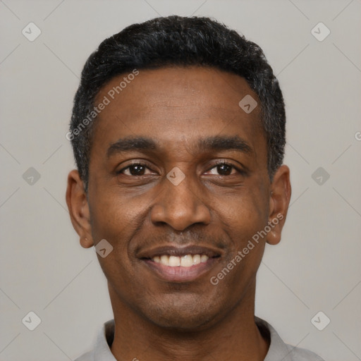 Joyful black young-adult male with short  black hair and brown eyes