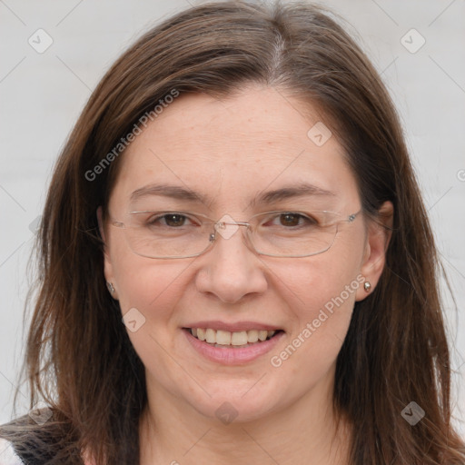 Joyful white adult female with long  brown hair and grey eyes