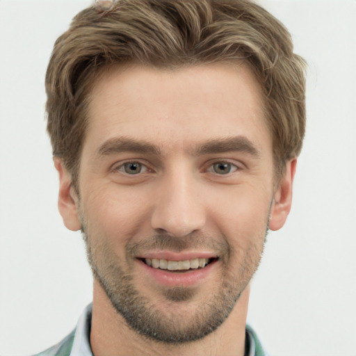 Joyful white young-adult male with short  brown hair and grey eyes