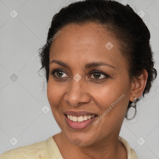 Joyful latino adult female with medium  brown hair and brown eyes