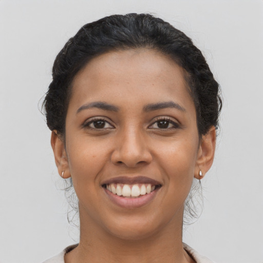 Joyful latino young-adult female with short  brown hair and brown eyes