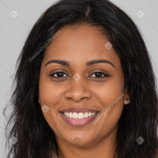 Joyful black young-adult female with long  brown hair and brown eyes