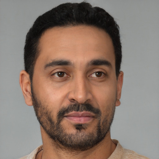 Neutral latino young-adult male with short  black hair and brown eyes