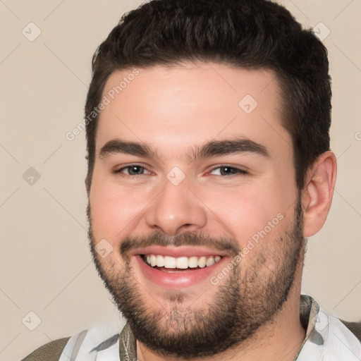 Joyful white young-adult male with short  brown hair and brown eyes