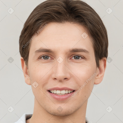 Joyful white young-adult male with short  brown hair and grey eyes