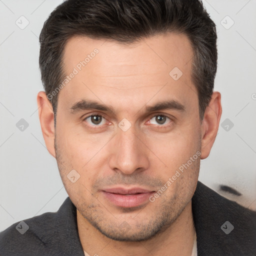 Joyful white adult male with short  brown hair and brown eyes