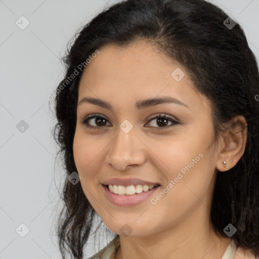 Joyful latino young-adult female with long  brown hair and brown eyes