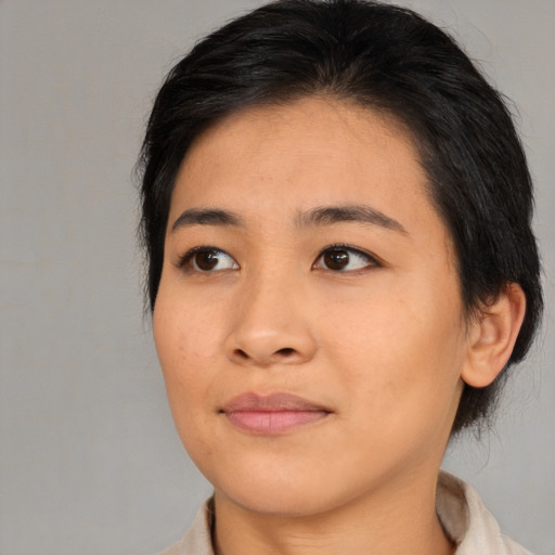 Joyful asian young-adult female with medium  brown hair and brown eyes