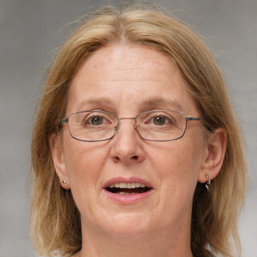 Joyful white middle-aged female with medium  brown hair and blue eyes