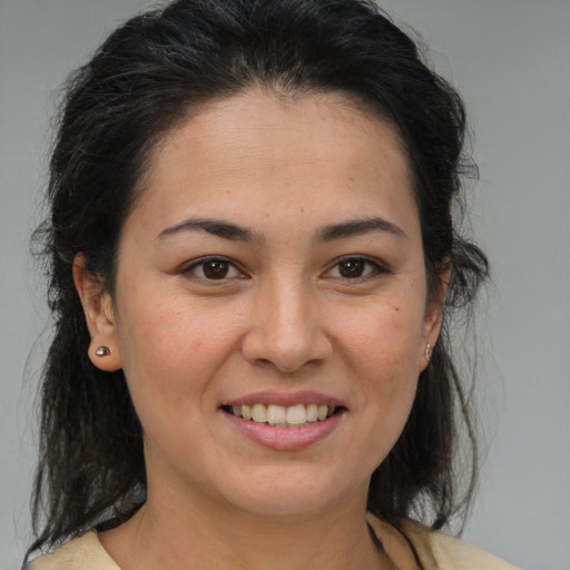 Joyful latino young-adult female with medium  brown hair and brown eyes