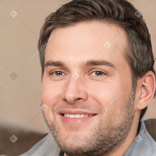 Joyful white adult male with short  brown hair and brown eyes