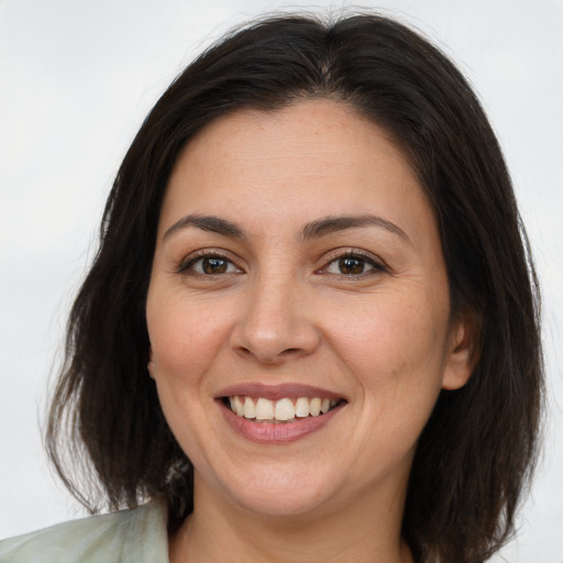 Joyful white adult female with medium  brown hair and brown eyes