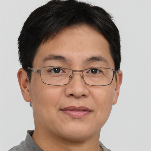 Joyful asian adult male with short  brown hair and brown eyes