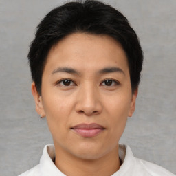 Joyful asian young-adult female with short  black hair and brown eyes