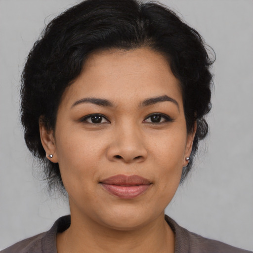 Joyful asian young-adult female with medium  black hair and brown eyes