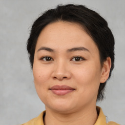 Joyful asian adult female with medium  brown hair and brown eyes