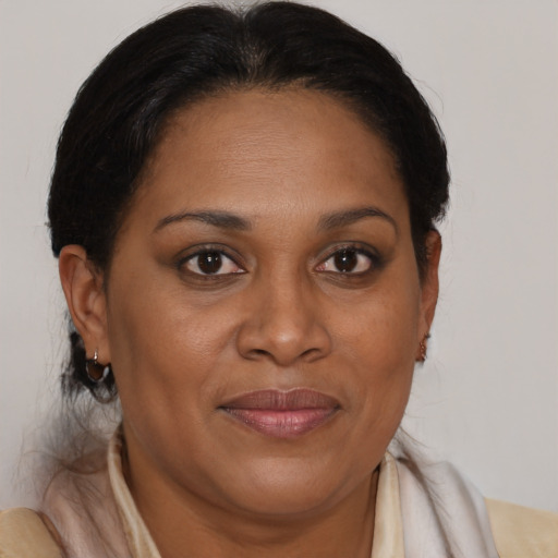 Joyful black adult female with medium  brown hair and brown eyes