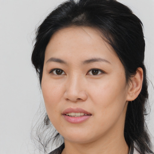 Joyful asian young-adult female with medium  brown hair and brown eyes