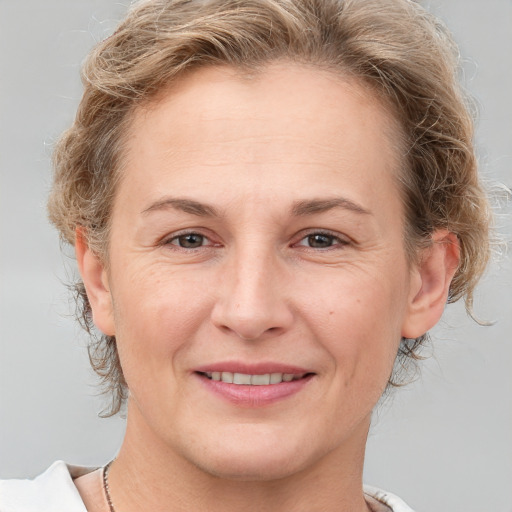 Joyful white adult female with medium  brown hair and grey eyes