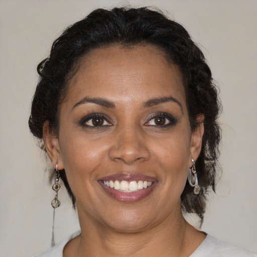 Joyful black young-adult female with medium  brown hair and brown eyes