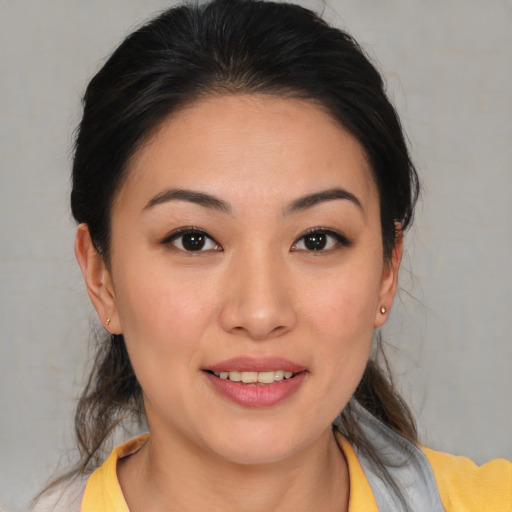 Joyful asian young-adult female with medium  brown hair and brown eyes