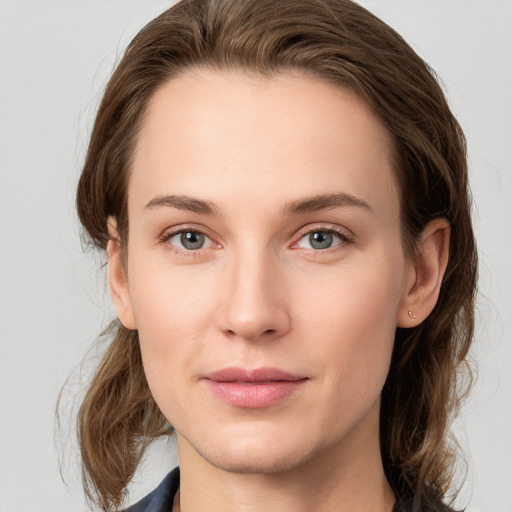 Joyful white young-adult female with medium  brown hair and green eyes