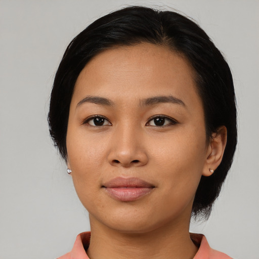 Joyful asian young-adult female with medium  black hair and brown eyes