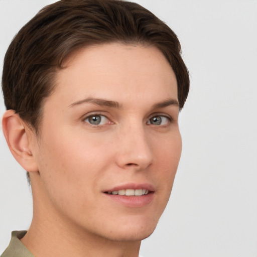 Joyful white young-adult female with short  brown hair and grey eyes