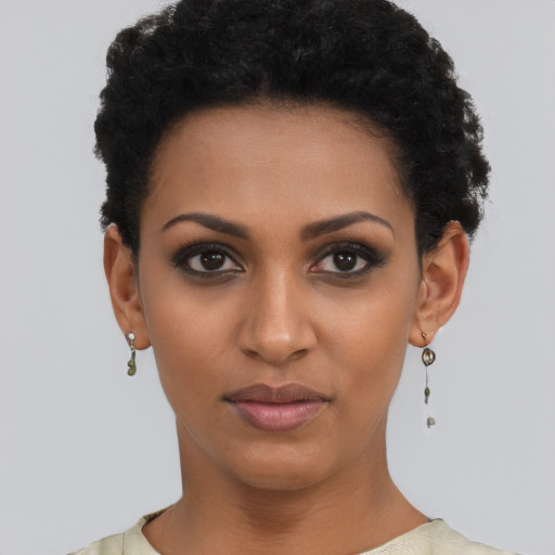Joyful black young-adult female with short  black hair and brown eyes