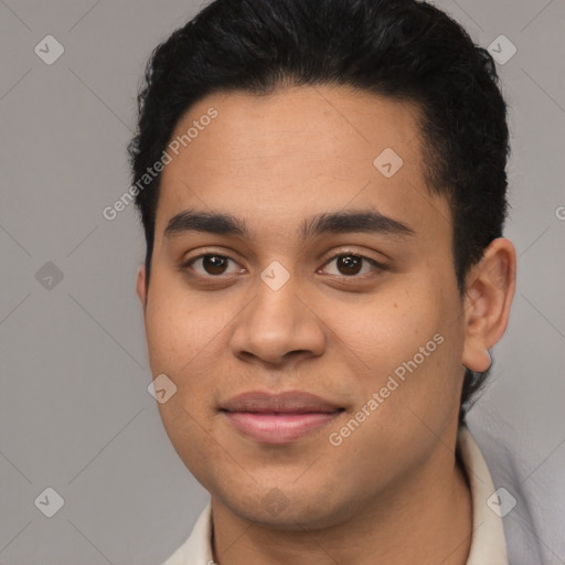 Joyful latino young-adult male with short  black hair and brown eyes