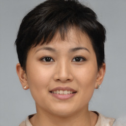 Joyful asian young-adult female with short  brown hair and brown eyes