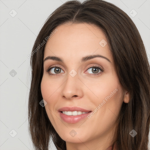 Joyful white young-adult female with long  brown hair and brown eyes