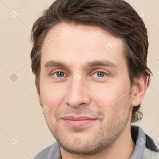 Joyful white young-adult male with short  brown hair and brown eyes