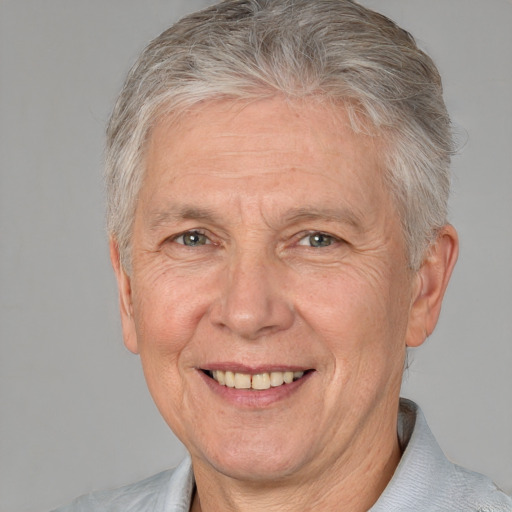 Joyful white middle-aged male with short  gray hair and brown eyes