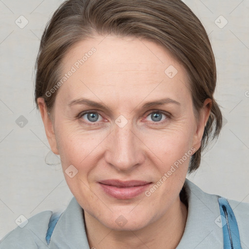 Joyful white adult female with medium  brown hair and blue eyes