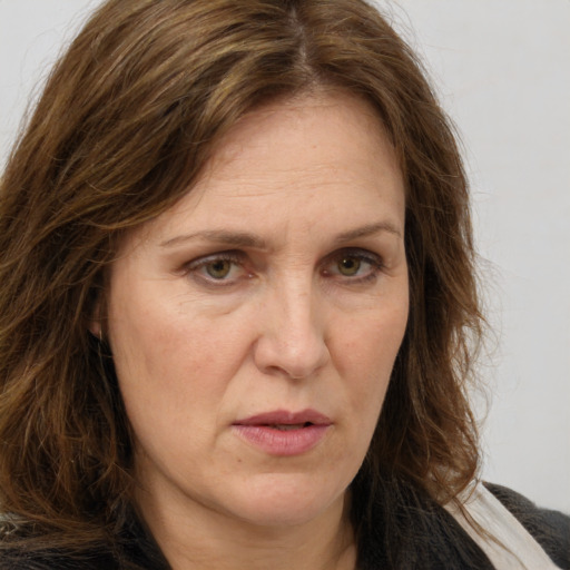 Joyful white adult female with long  brown hair and brown eyes