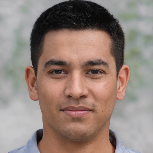 Joyful white young-adult male with short  black hair and brown eyes