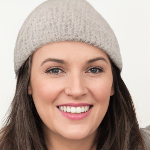 Joyful white young-adult female with long  brown hair and grey eyes